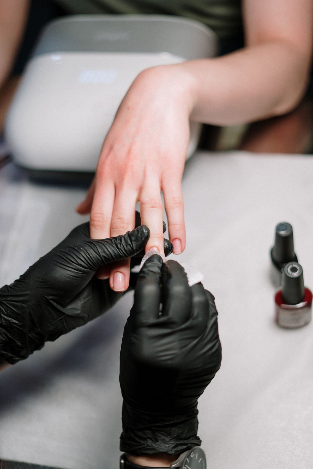 Acrylic nail application at Hello Bella Nail & Spa
